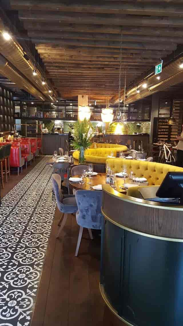 Kibele Restaurant's vibrant yellow seating for intimate meetings and events.