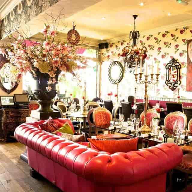 Elegant Rock & Rose Restaurant with floral wallpaper, perfect for upscale events and gatherings.