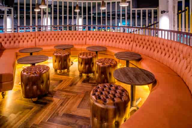 Stylish lounge at Swingers City, featuring curved leather seating for networking events.