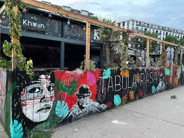 Vibrant outdoor venue with murals for creative events and casual meetups.