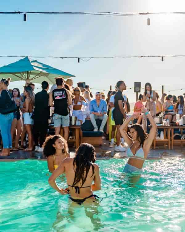 Vibrant poolside event at The Highlight Room with lounge seating and summer vibes.
