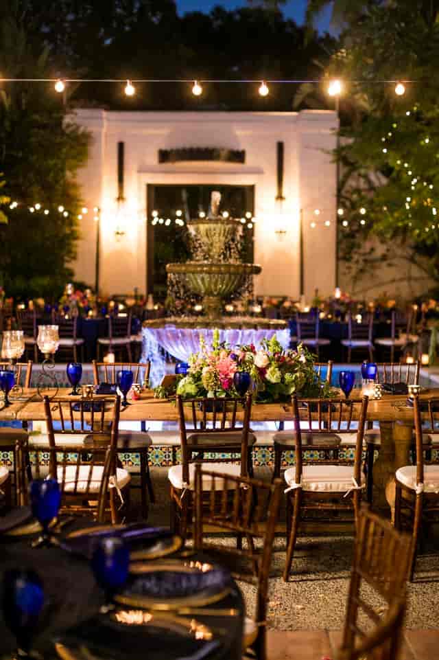 Elegant outdoor event space with fountain, floral decor for upscale gatherings.