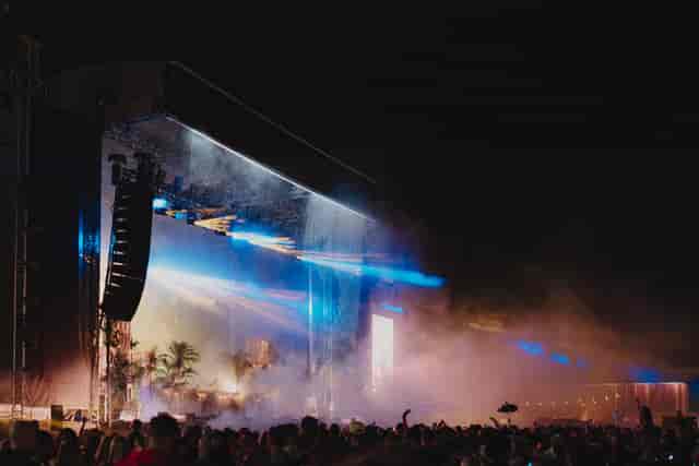 Vibrant outdoor event at Silverworks Island with dynamic stage lighting and enthusiastic crowd.