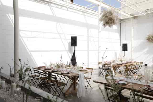 Elegant event venue in The Revery LA with wooden tables, ideal for gatherings and celebrations.