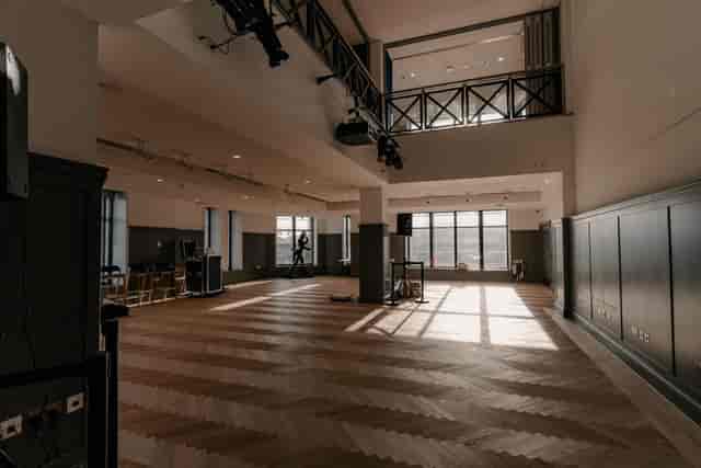 Spacious Blue Room venue with large windows, perfect for corporate events and gatherings.
