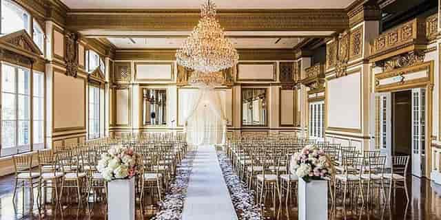 King Edward in Alexandria Ballrooms: elegant wedding venue with chandelier and floral decor.