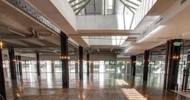 Spacious event venue with high ceilings, ideal for weddings and conferences.