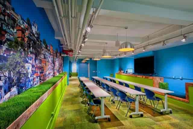 Vibrant OFFSITE meeting space with blue walls, ideal for workshops and collaboration.