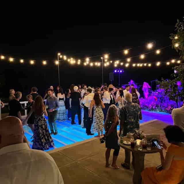 Queens Event Hall outdoor party with string lights and floral decor for celebrations.