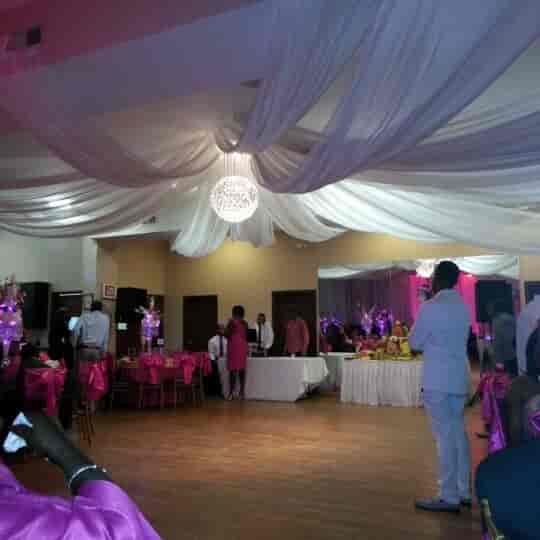 Elegant banquet hall with pink accents, perfect for weddings and formal events.