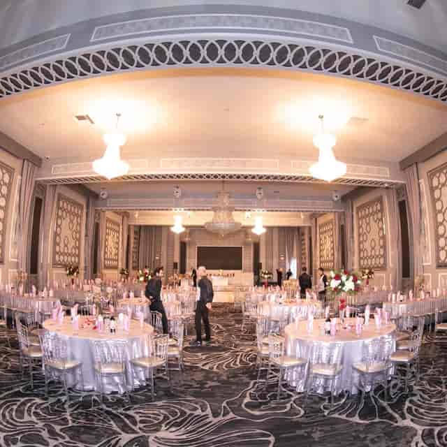 Elegant Quinceañera reception hall in L.A. with pink accents and chandeliers.