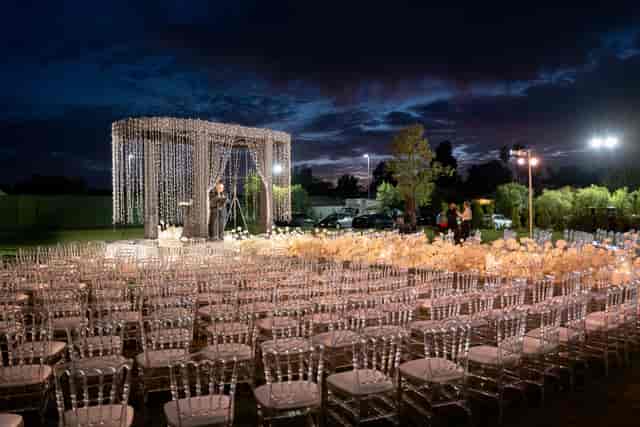 Elegant outdoor wedding venue in L.A. with decorated stage and romantic lighting.