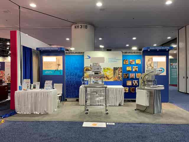 Trade show exhibit booth with branded graphics and engaging layout for events.