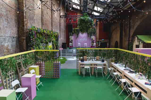 Vibrant event space at Village Underground with lush greenery for networking and workshops.