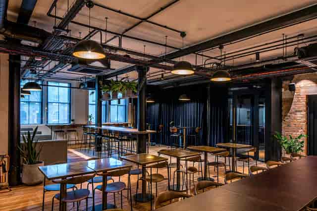 Modern event space with high tables, ideal for networking and gatherings.
