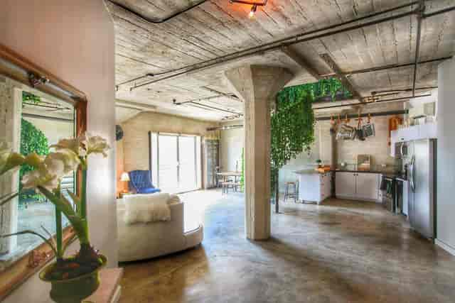 Versatile event space with natural light and greenery for workshops and gatherings.