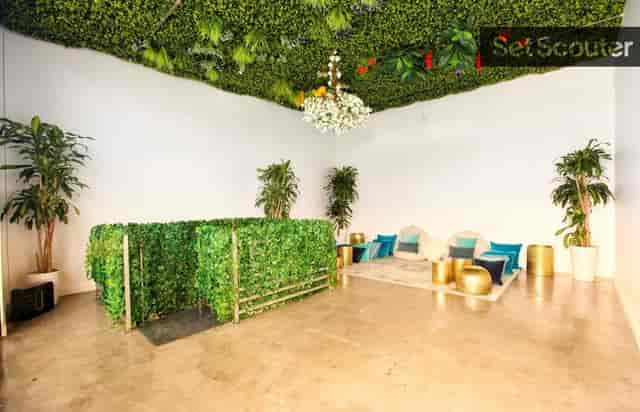 Versatile event space with lush green ceiling, perfect for meetings and gatherings.