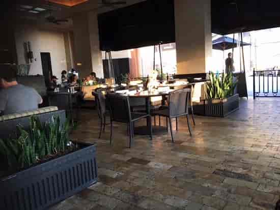 Modern patio dining area at The Cheesecake Factory, perfect for casual meetings and events.