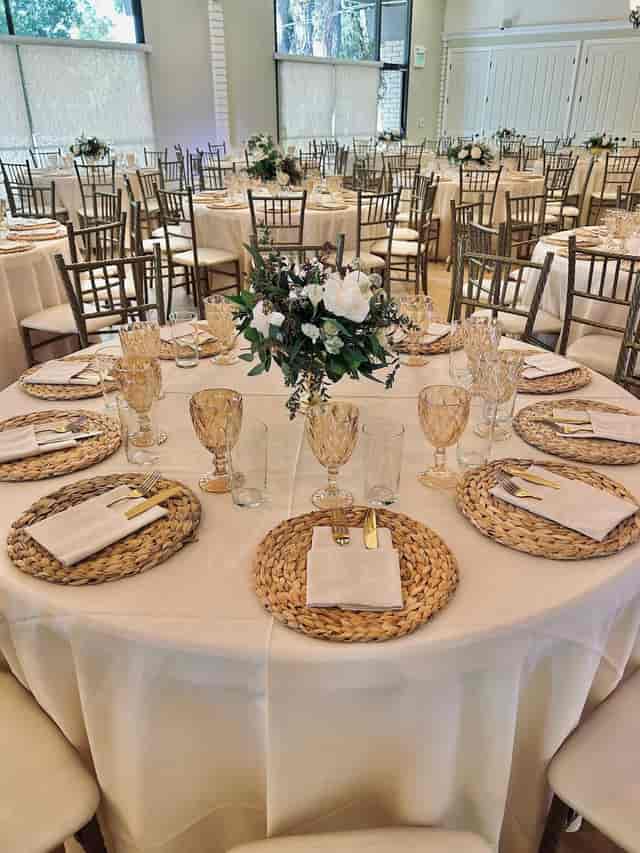 Elegant dining table setup with floral centerpiece for weddings and formal events.