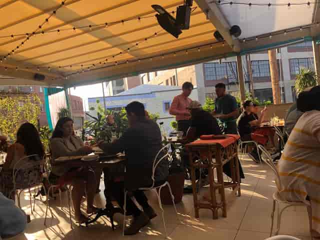Vibrant covered patio dining space for casual meetings and networking events.