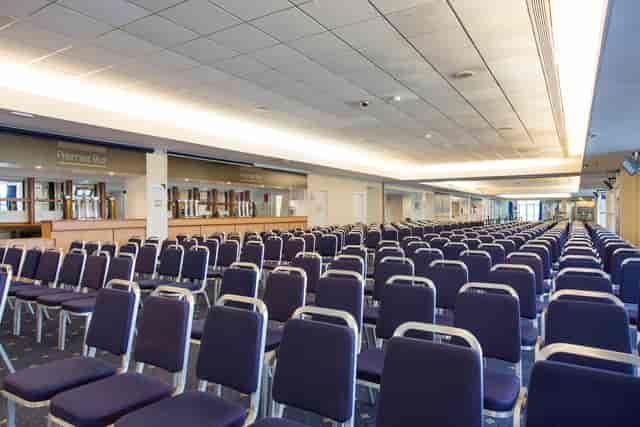 Premier Suite at Kempton Park Racecourse with purple chairs for conferences and seminars.