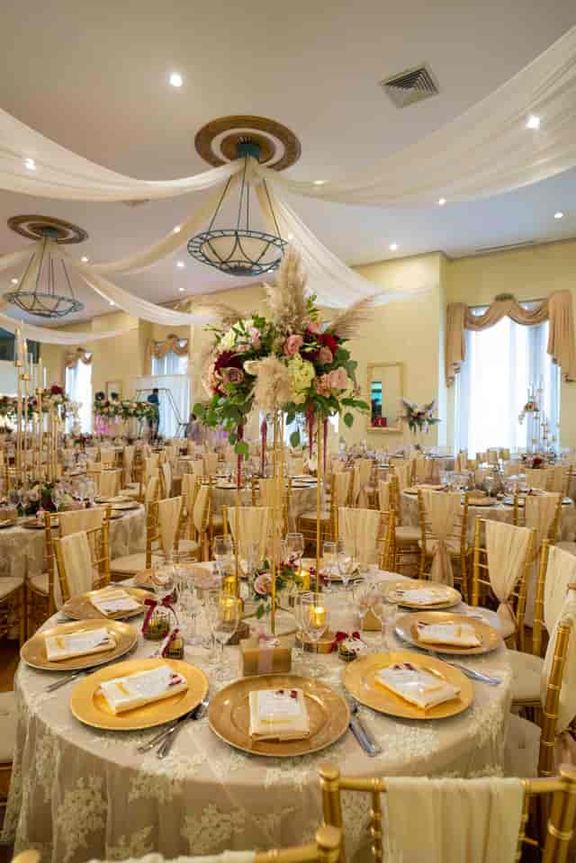 Elegant Grand Ballroom with floral centerpieces for upscale weddings and events.