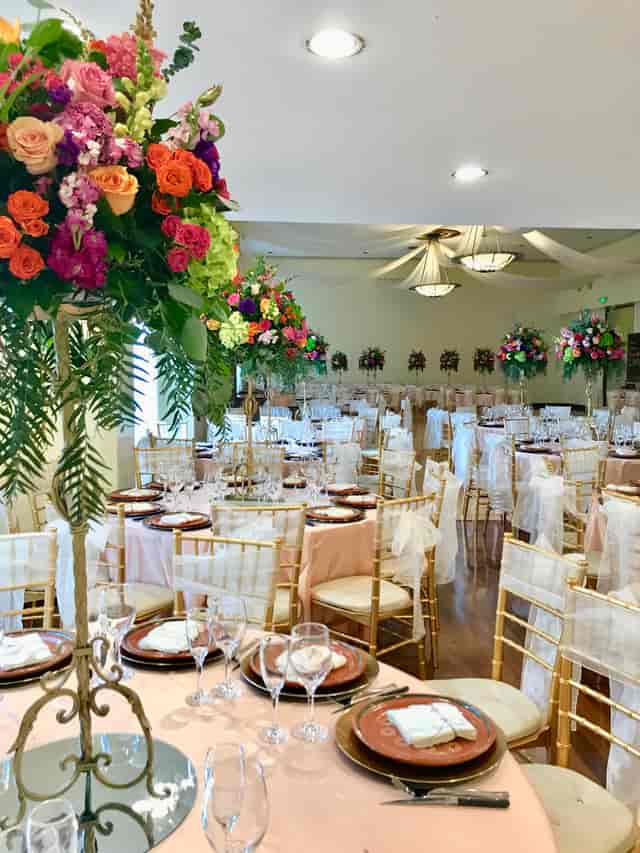 Elegant Grand Ballroom with pink linens, ideal for weddings and galas.