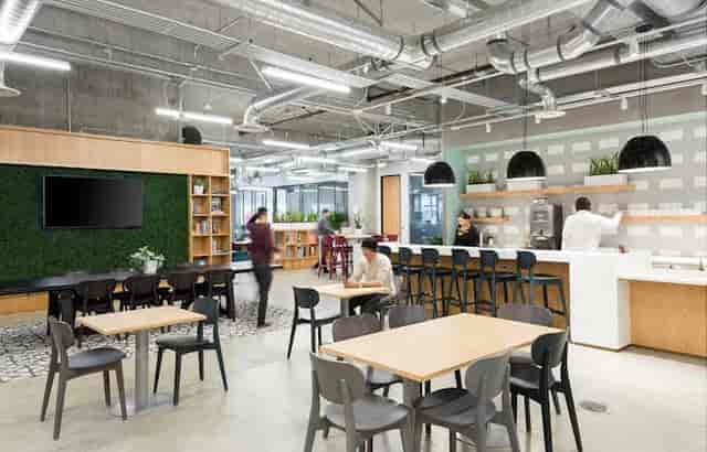 Modern coworking area with greenery wall, ideal for networking events and collaboration.