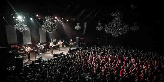 Vibrant live music event at Music Hall in The Fillmore with elegant chandeliers.