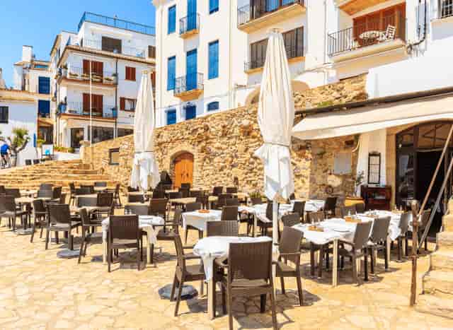 Private hire outdoor dining area at Salty Olive with stone backdrop, ideal for events.