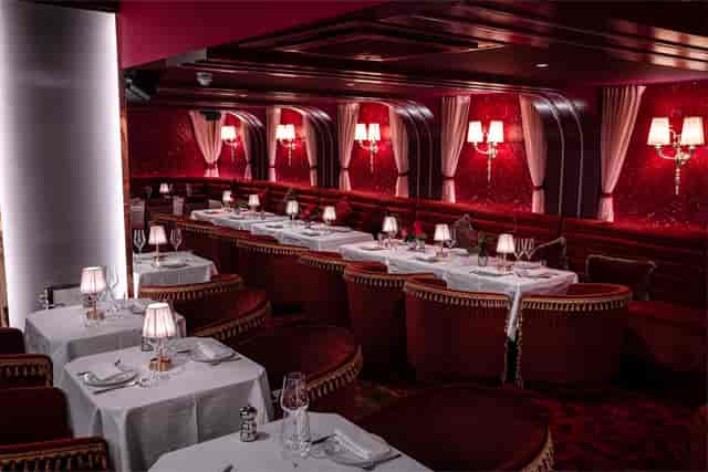 Elegant semi-private dining area with plush seating for upscale events and gatherings.