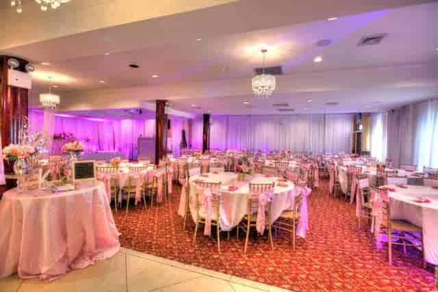 Elegant event venue with soft pink lighting, ideal for weddings and formal gatherings.