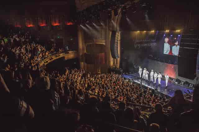 Vibrant live concert at The Warfield with engaged audience and professional stage setup.