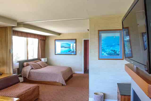 Cozy hotel room with fireplace, ideal for retreats and meetings at Seal Rock Inn.