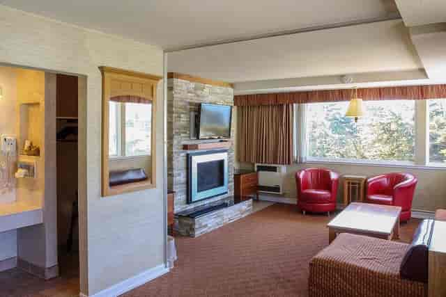 Cozy hotel suite with fireplace, perfect for meetings and relaxation at Seal Rock Inn.