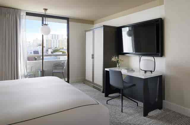 Modern hotel room with balcony, ideal for business travelers and events at Kimpton Hotel Enso.