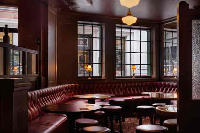 Cozy dining room with rich wood paneling, perfect for networking events and meetings.