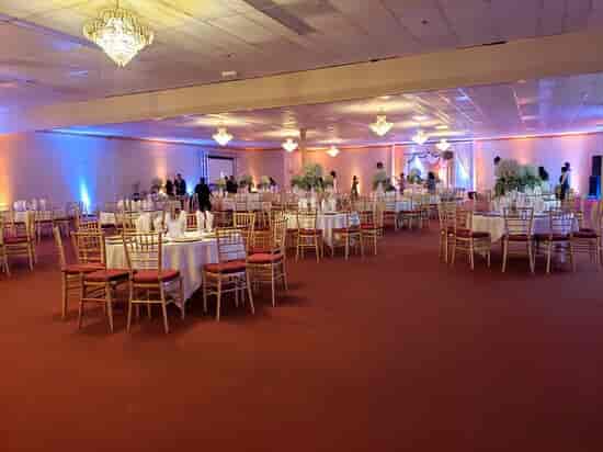 Elegant banquet room with white linens, ideal for weddings and corporate events.