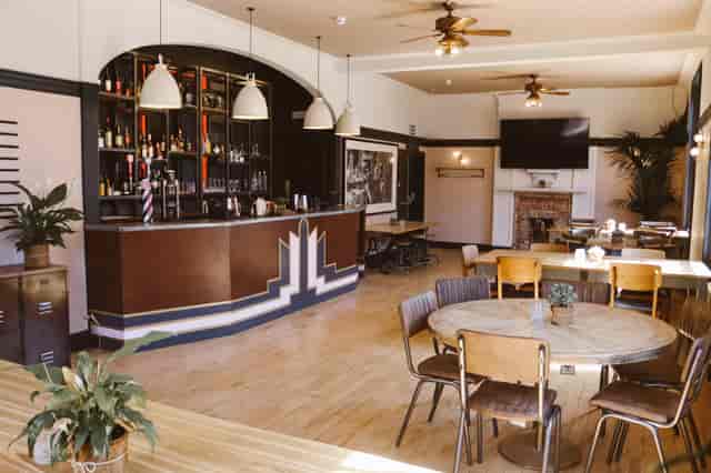 Versatile event space with stylish bar, ideal for gatherings and networking events.