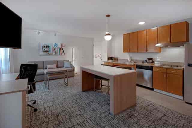 Modern kitchen and living area in Homewood Suites, perfect for meetings and networking.