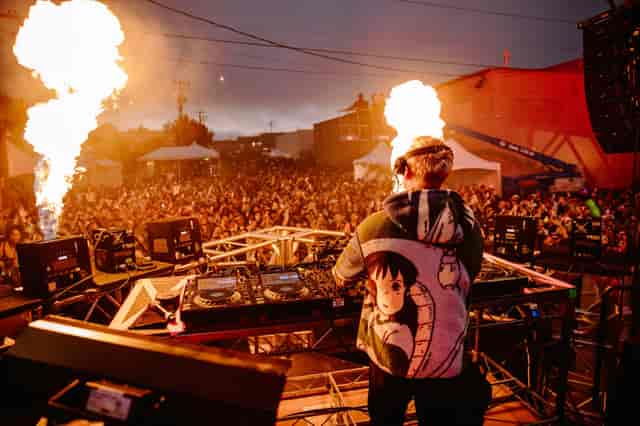 Block Party in The Midway with DJ and pyrotechnics, vibrant outdoor event entertainment.