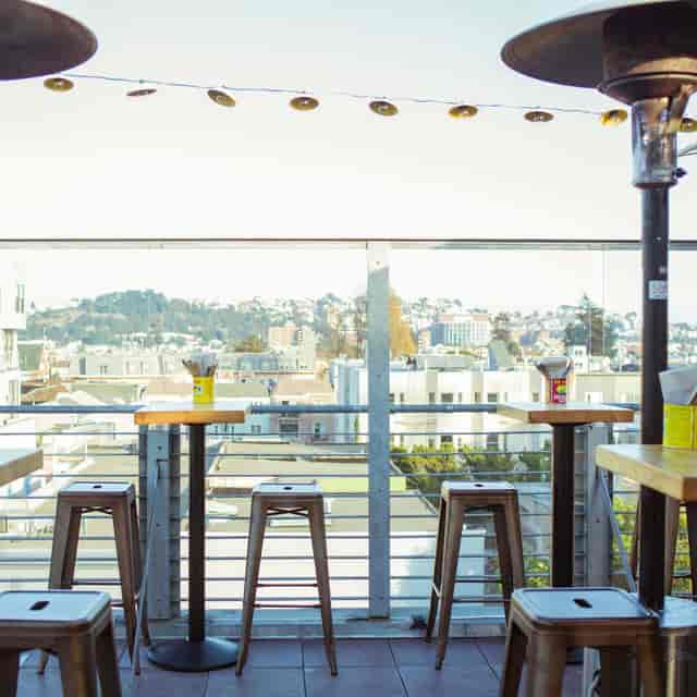 Stylish rooftop patio with city view, ideal for networking events and casual meetings.