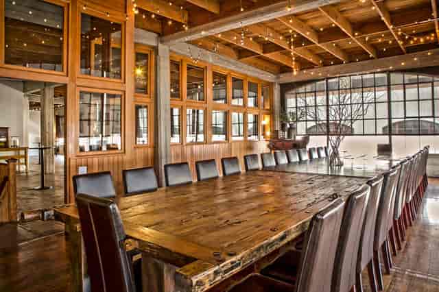 Stylish Amador Club event space with rustic table, ideal for gatherings and workshops.