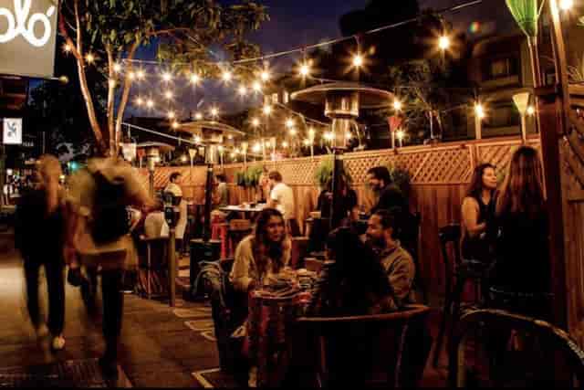 Vibrant outdoor dining space with string lights for casual networking events.