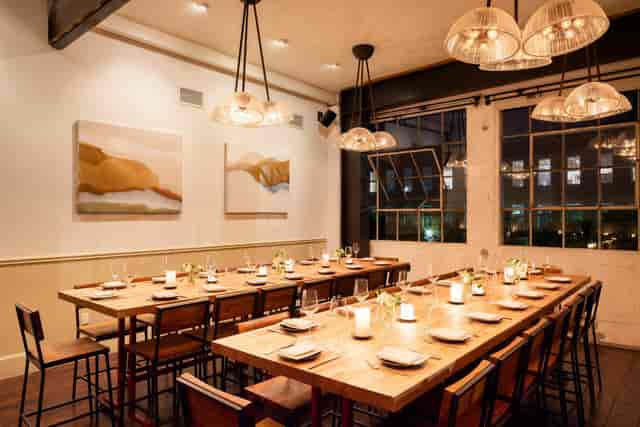 Stylish dining space with wooden table, ideal for intimate gatherings and corporate dinners.