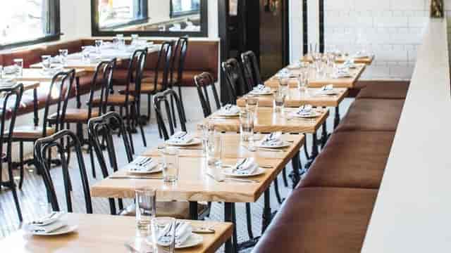 Communal table in Marlowe, modern decor for events and meetings, inviting atmosphere.