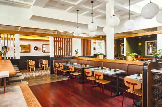 Modern Delfina Restaurant with vibrant seating, perfect for intimate meetings and events.