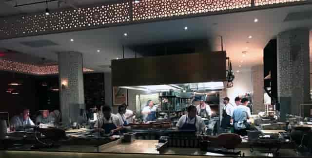 Bellota SF kitchen showcasing chefs in action for interactive dining events.
