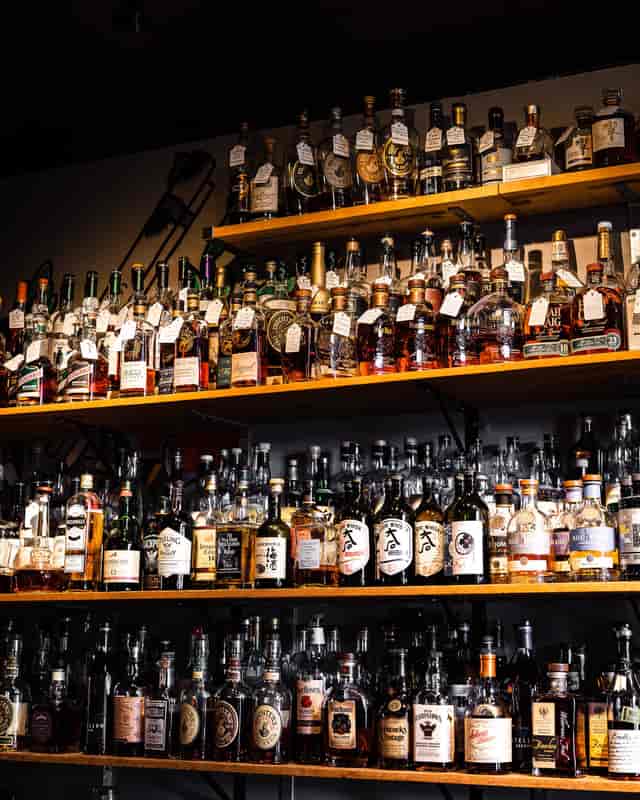 Private room bar at Acme Bar & Company with diverse spirits for events and tastings.