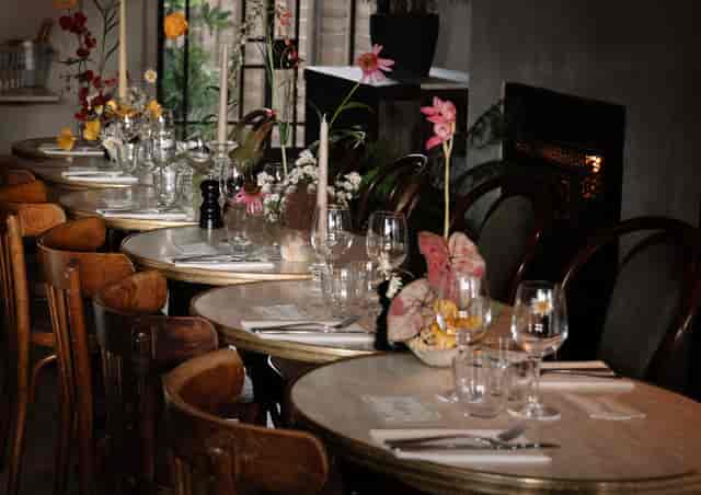 Private dining room with elegant setup, floral centerpieces for weddings and events.